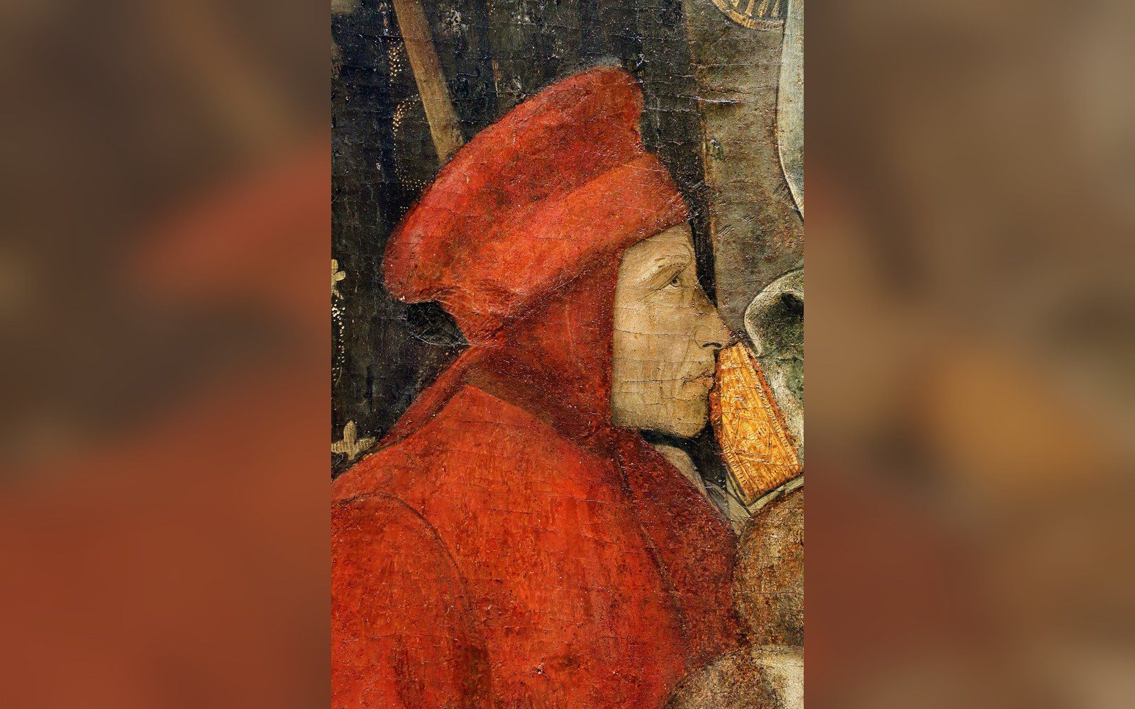 Detail from a Renaissance painting showing a profile figure in a red hat and robe